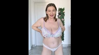 Busty granny teasing you with huge tits stripping in lingerie
